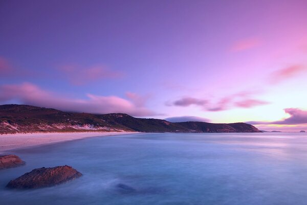 Lilac sunset over the sea surface