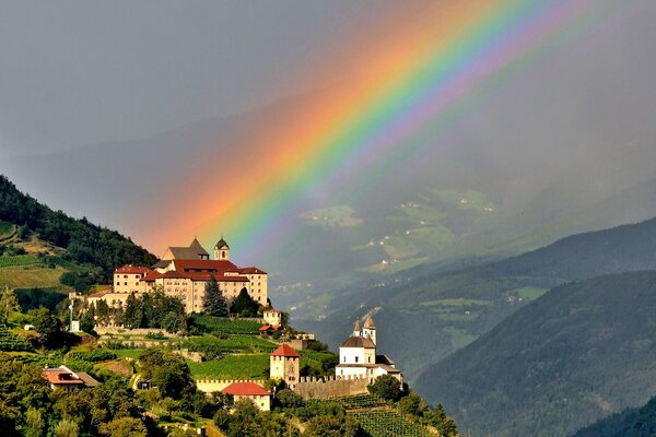 Landscape with a castle in the mountains and a rainbow
