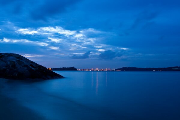 Twilight with lights on the background of the sea