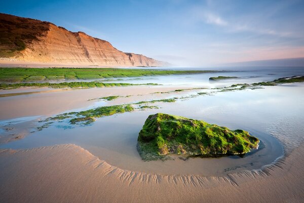 Green stone in a small bay