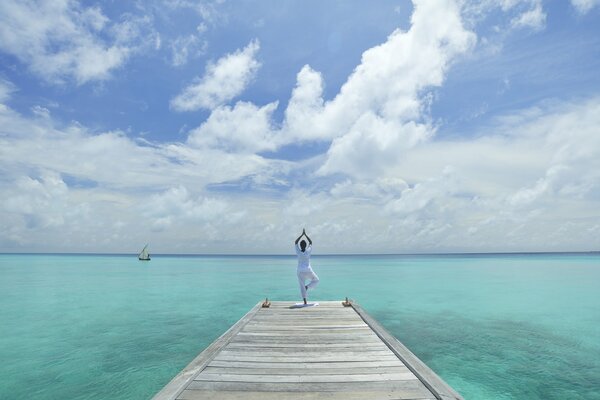 Blue lagoon girl doing yoga