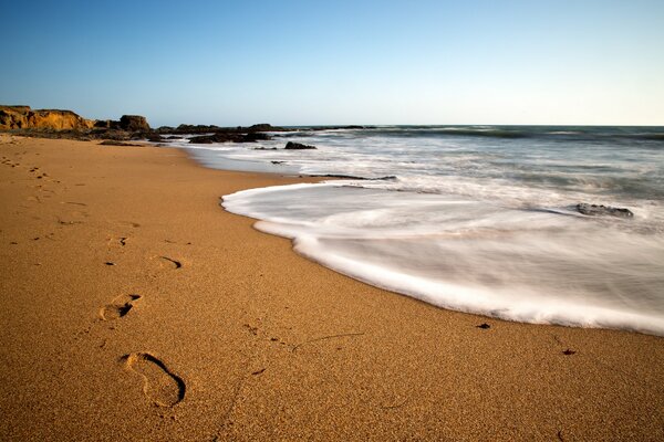 Air sea foam is whipped on the sand