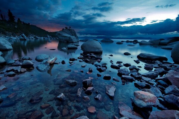 A night lake strewn with rocks