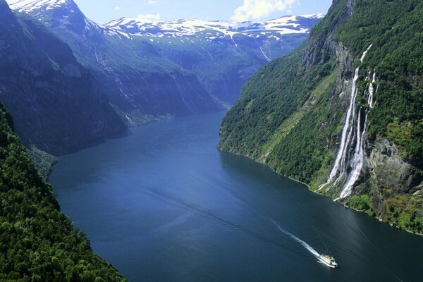 Boat trip through the mountains with a waterfall