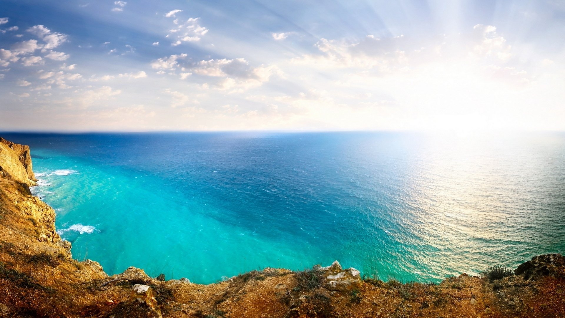 paisaje mar océano rocas sol cielo nubes naturaleza