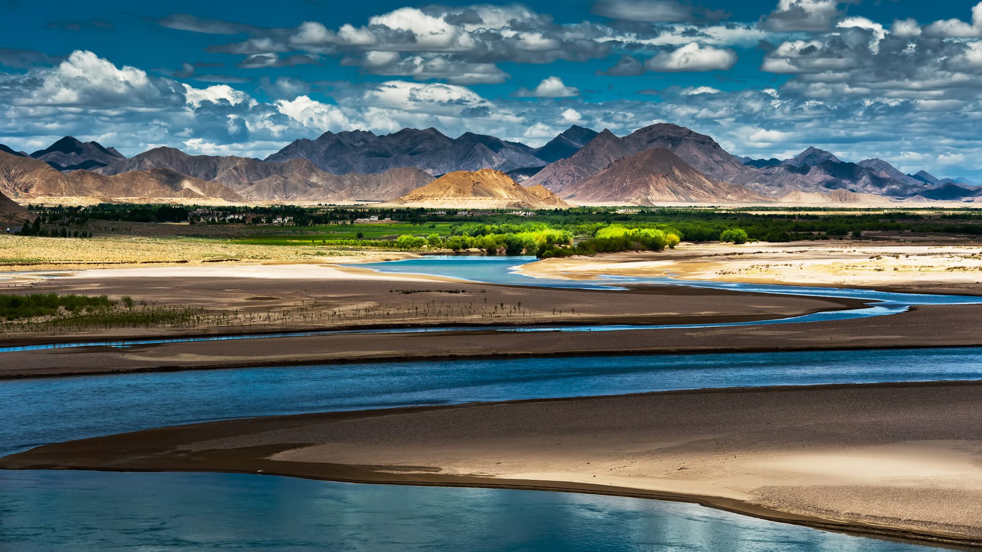 china tibet oasis river mountain sky clouds shadow light