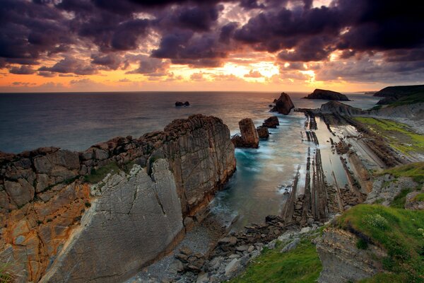 Rocks in the gray sea at sunset