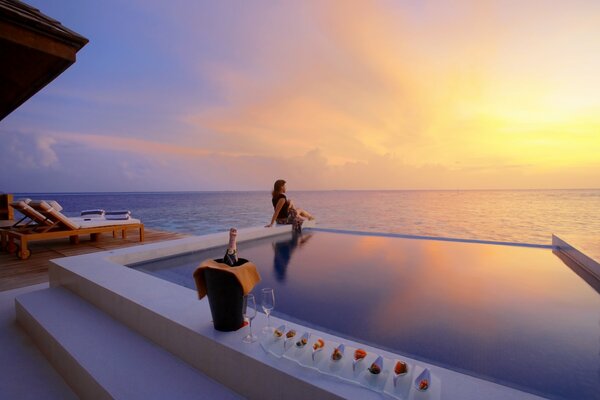 Vacation with champagne and strawberries by the pool