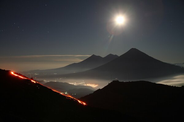 Volcanic eruption near the city in the mountains