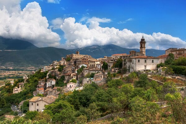 Castle on a mountain in the middle of houses in Italy