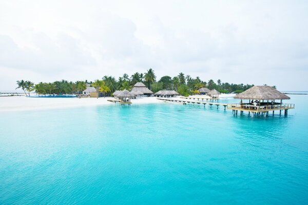 An island with white sand on blue water. Vacations and travel