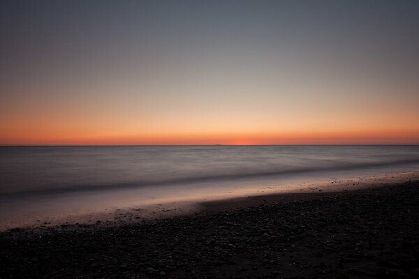 Landscape evening beach shore and pebbles