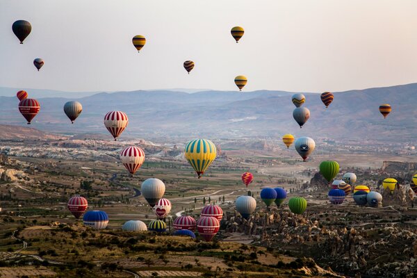 Lots of balloons over the green valley