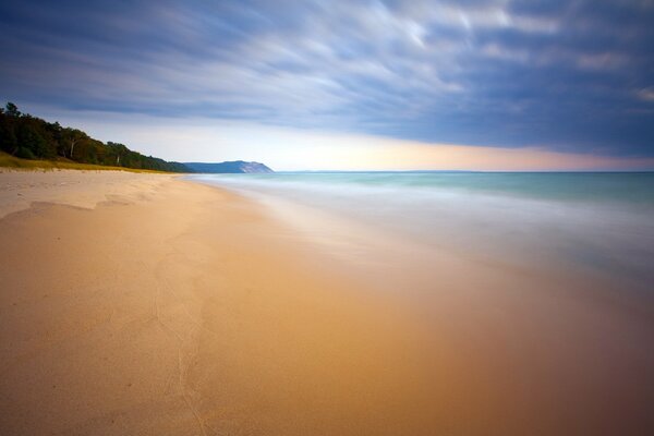 The deserted shore of the azure sea