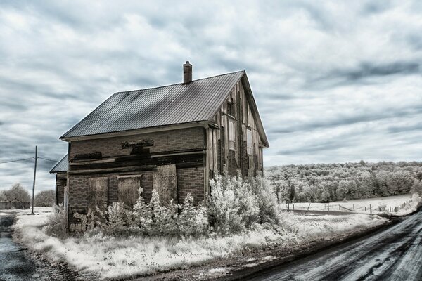 A snowy road and a lonely house