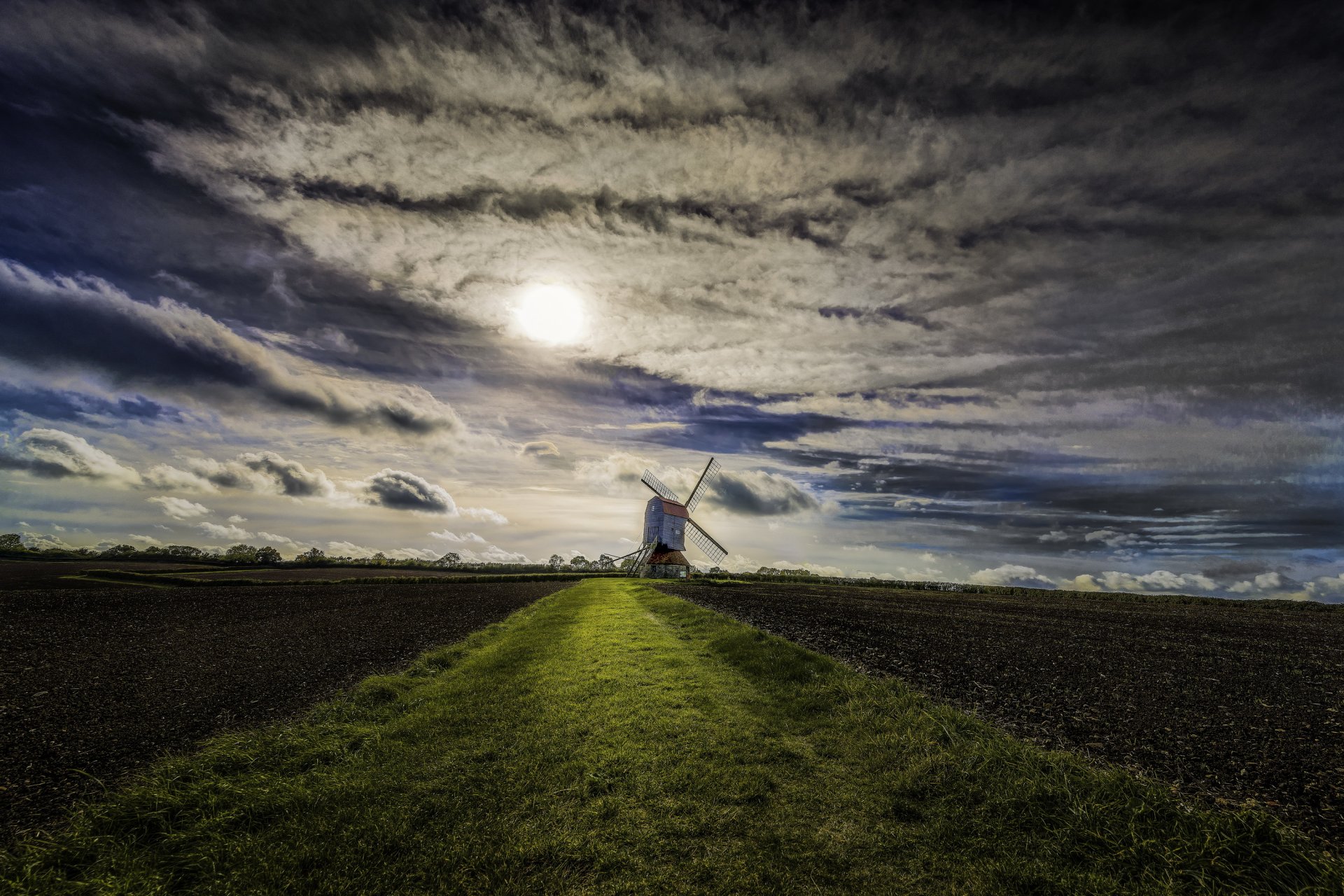 tevington england the field windmill sky clouds . sun