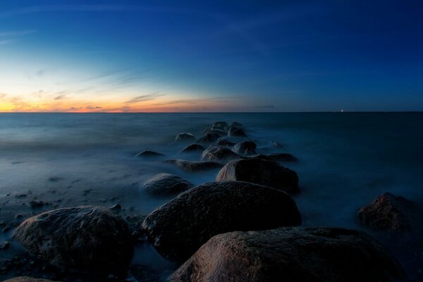 Sea night landscape gray stones