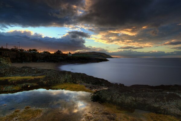 Cloudy landscape over the settlement of people and the sea