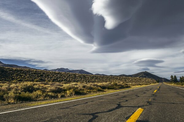 A long road. A storm overhead