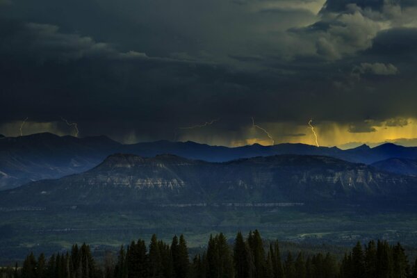 Dark clouds over the mountain in the forest