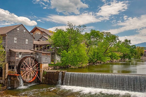 Watermill in summer on the river bank