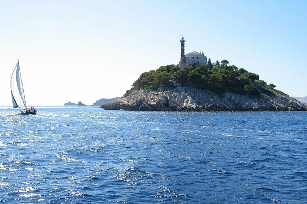 A lonely sail in the blue sea