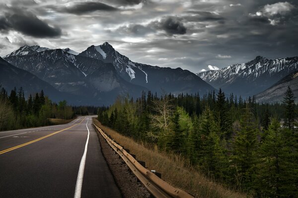 Canadian road through the forest to the mountains