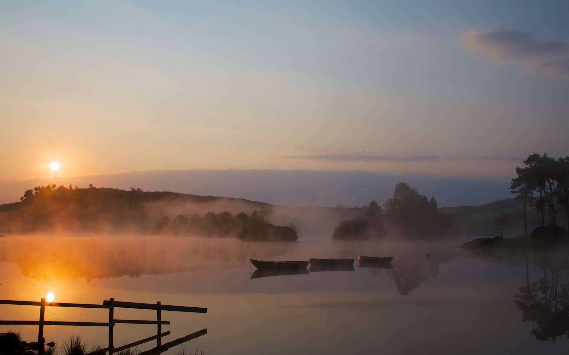 lago mañana niebla barcos