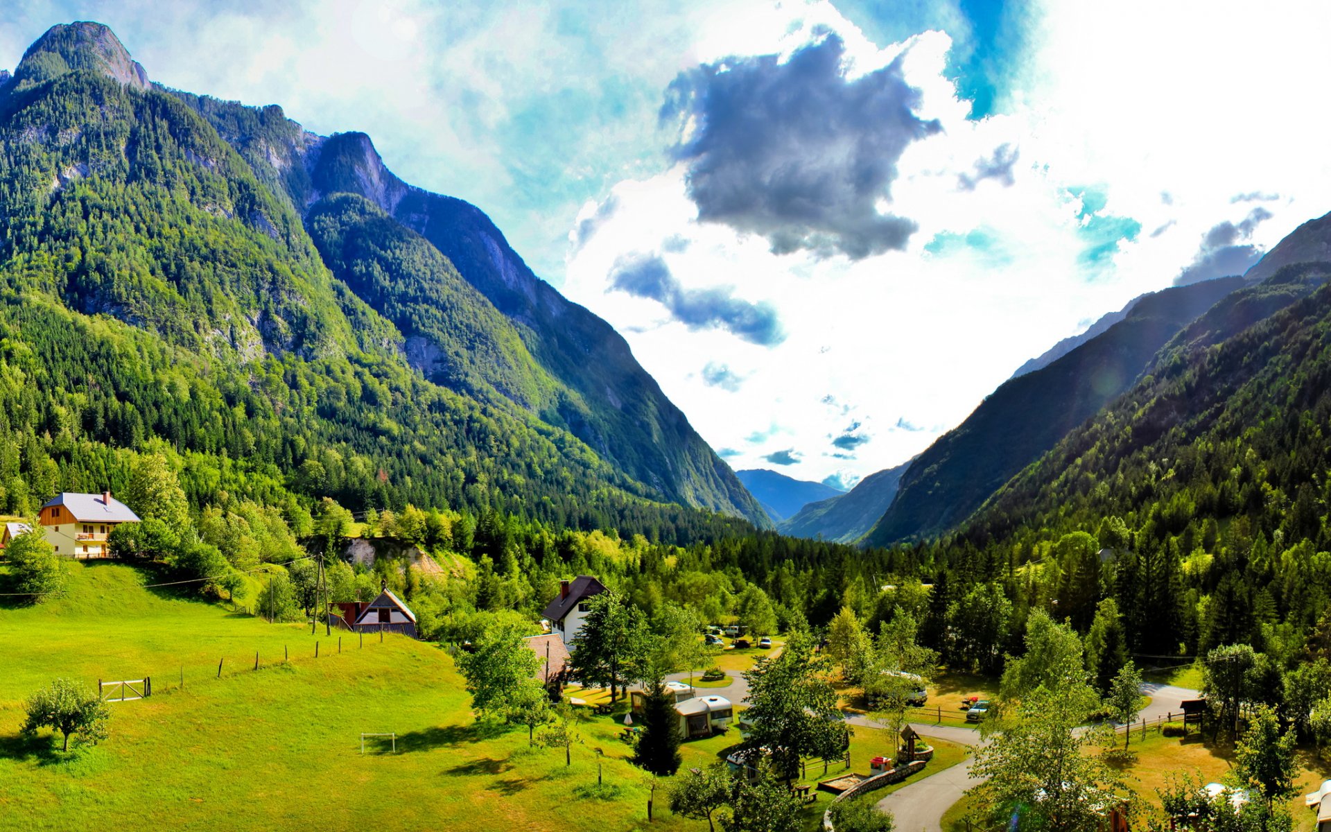 bovec slowenien himmel wolken berge häuser bäume gras natur straße tal