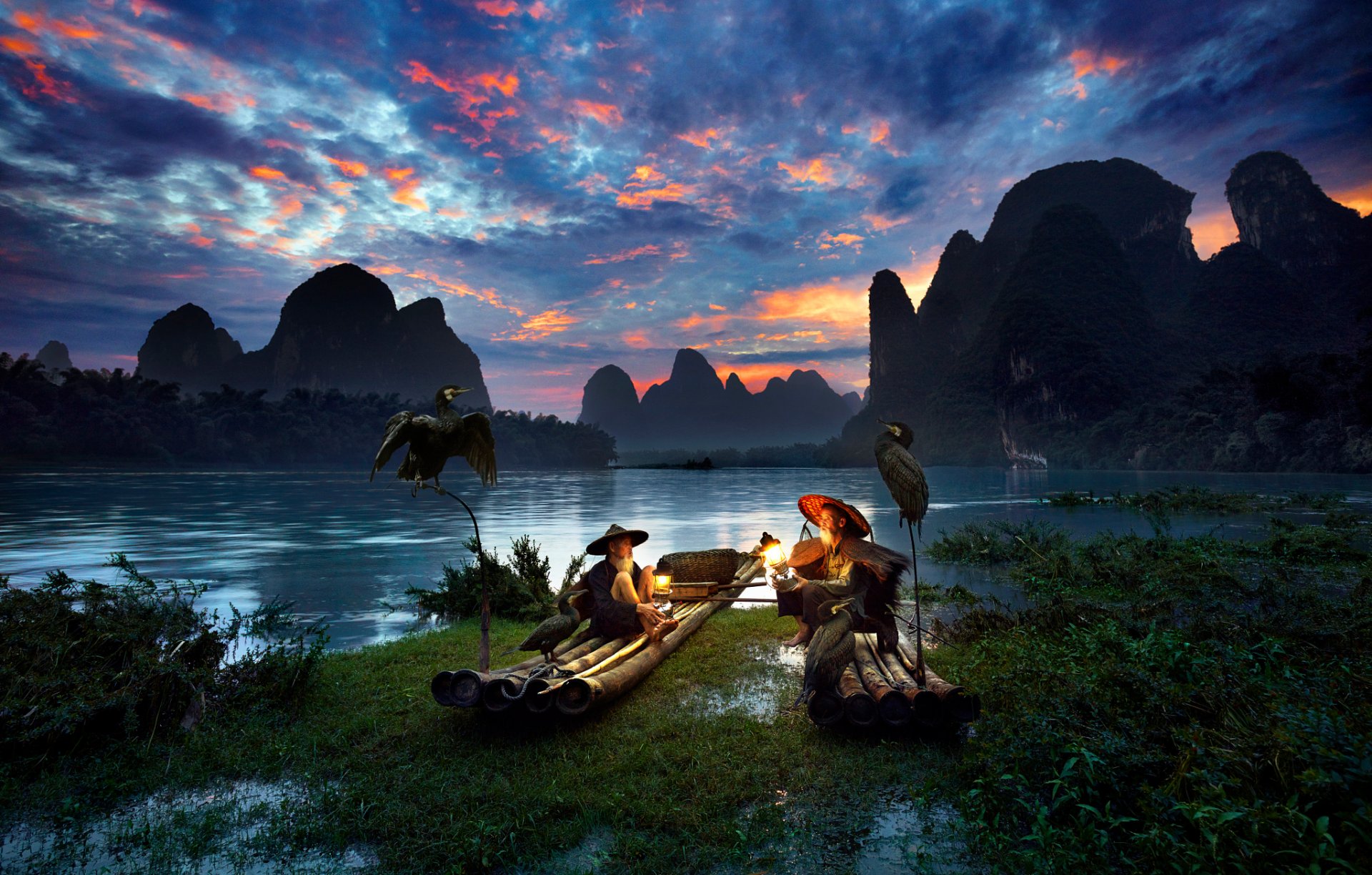 china region of guangxi zhuang river fishermen boat lamps birds cormorants night