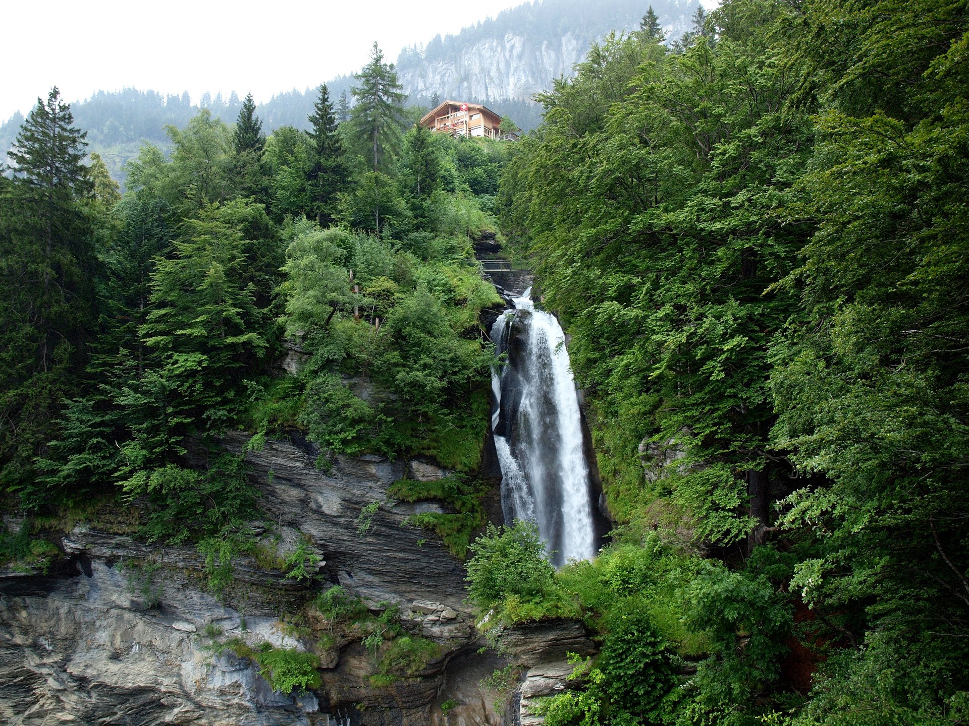 reichenbach switzerland sky mountain tree house waterfall