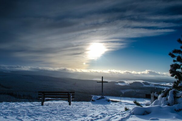 A lonely cross in the mountains. Evening