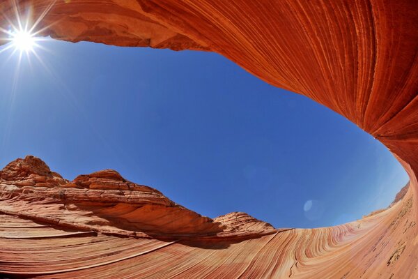 Through the sandstone you can see the blue sky and the sun