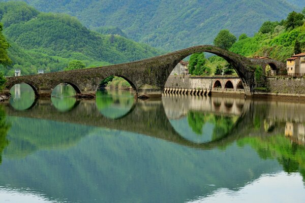 Nature of Italy with the image of a bridge over a river