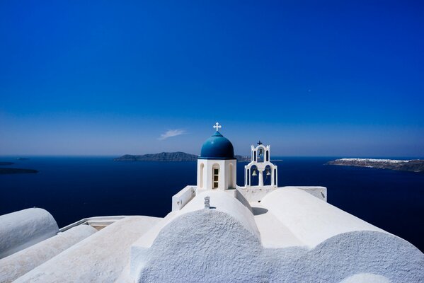 Church on the background of the blue sea in Santorini
