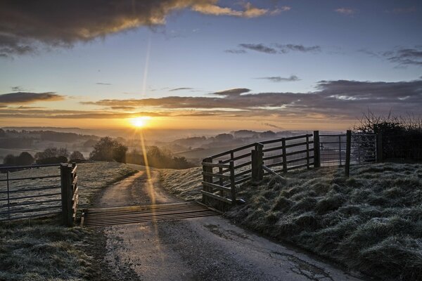 Winter road on the background of the setting sun