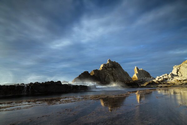 Landscape, with jagged rocks floating out of the sea