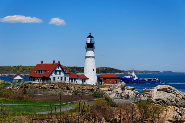 Oregon lighthouse with a house and a ship