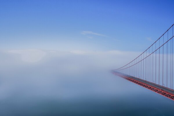 Suspension bridge in the fog in the early morning