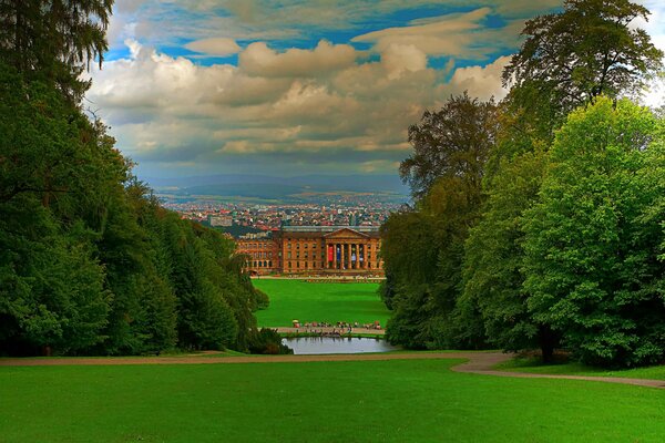 Green park with a lake and houses