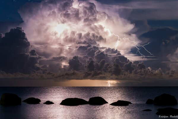 Night cloud with lightning over the sea