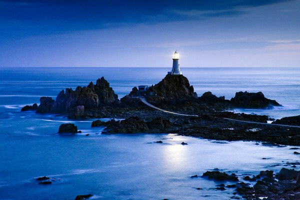 Seascape with lighthouse and rocks