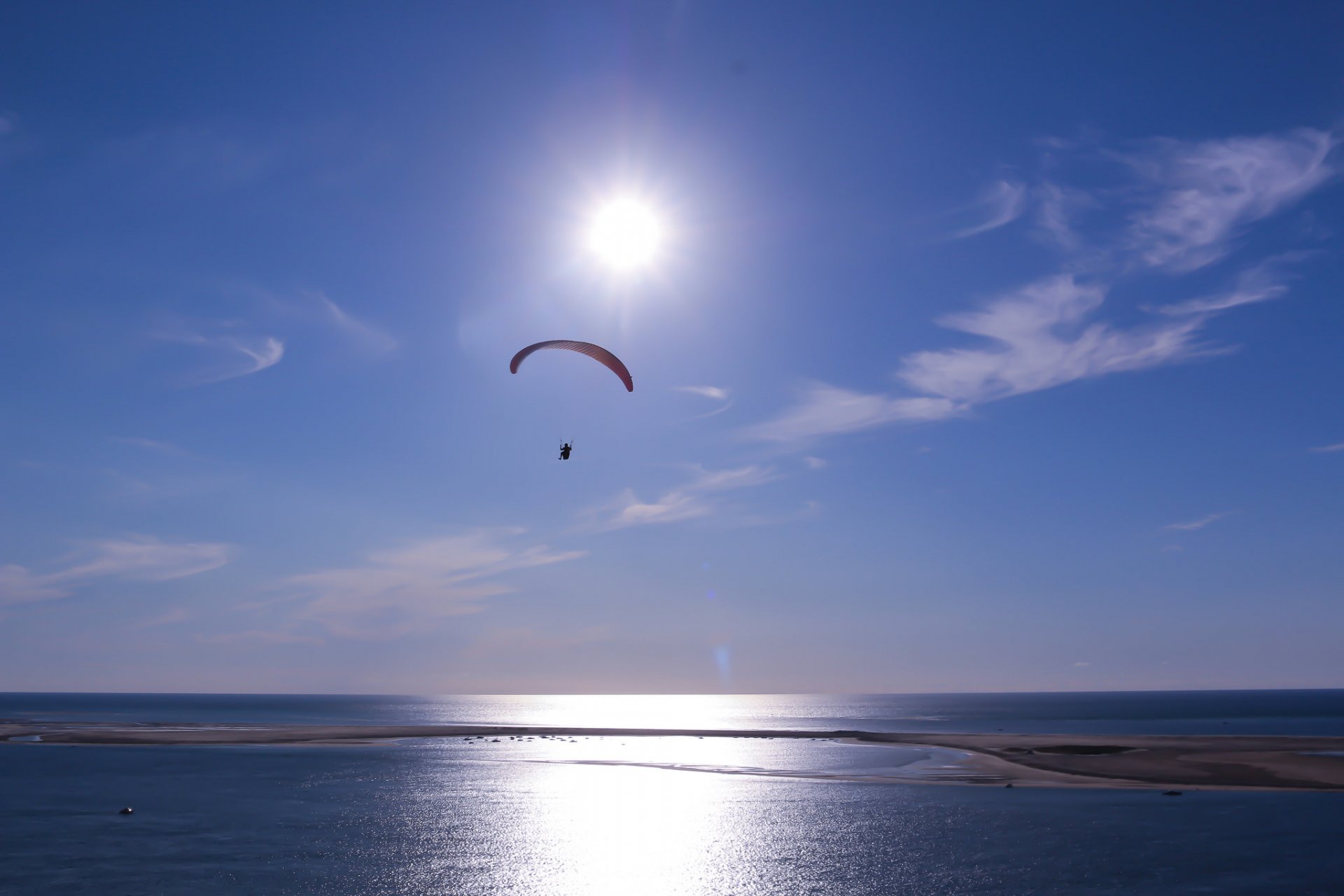 ky clouds sun sea parachute paragliding