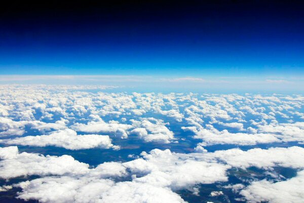 View from an airplane among white clouds