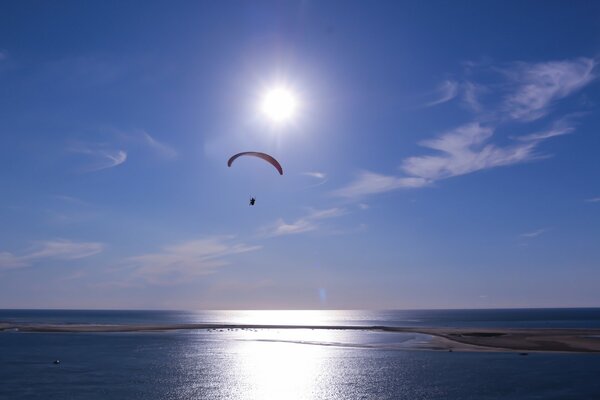 A parachutist flying against the background of a wonderful sky