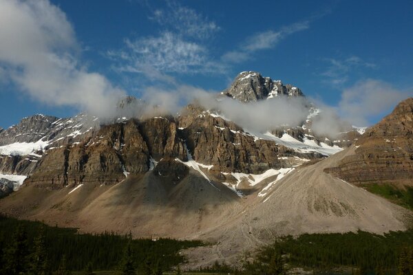 Schneebedeckte Gipfel der Felsen vor dem Hintergrund des blauen Himmels