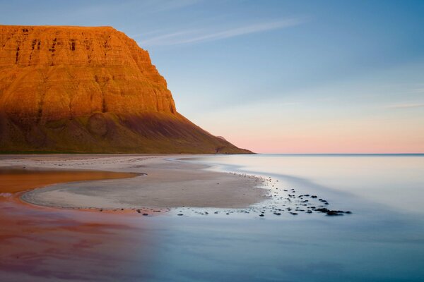 High sandy mountain on the shore