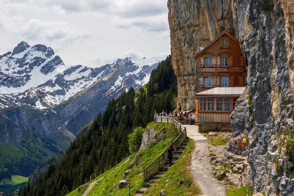 Mountain peaks in the snow. Cafe in the rock