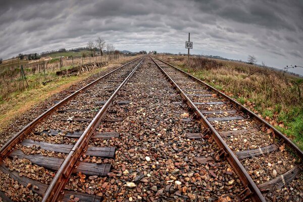 The railway under the gloomy autumn sky