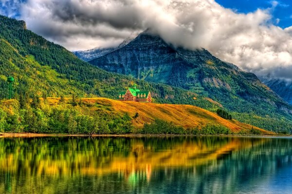 Casa solitaria en la orilla se refleja en el lago